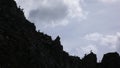 Many young ibex or alpine mountain goat standing in silhouette on a jagged mountain ridge