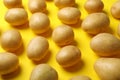 Many young potato on yellow background Royalty Free Stock Photo