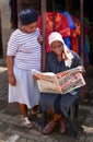 African woman reading the newspaper