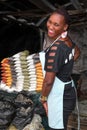 African lady posing at spices and herbs market stand