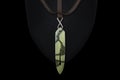 maori greenstone pounamu pendant lying on a black cloth Royalty Free Stock Photo