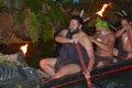 Maori man in traditional waka boat