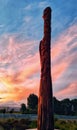 Maori phallic statue with sunset background