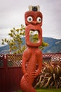 Maori statue with open mouth and big eyes in Rotorua, New Zealand