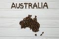 Map of the Australia made of roasted coffee beans laying on white wooden textured background Royalty Free Stock Photo