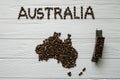 Map of the Australia made of roasted coffee beans laying on white wooden textured background with toy train Royalty Free Stock Photo