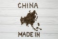 Map of the China made of roasted coffee beans laying on white wooden textured background Royalty Free Stock Photo