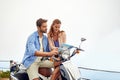 Map, couple and direction on vacation, scooter and guide on travel, explore and sightseeing in outdoors. People, trip Royalty Free Stock Photo