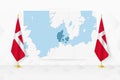Map of Denmark and flags of Denmark on flag stand Royalty Free Stock Photo