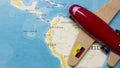 A map of Ecuador and a red plane with a flag of Ecuador attached to its wings. Royalty Free Stock Photo
