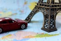 On the map is a toy car and the Eiffel Tower