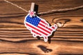 Map flag of America hanging on a rope on wooden clothespins. Rustic Christmas decoration.  Wooden boards background. USA. Concep Royalty Free Stock Photo