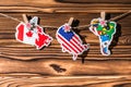 Map flag of North, South America, Canada hanging on a rope on wooden clothespins. Rustic Christmas decoration.  Wooden boards Royalty Free Stock Photo