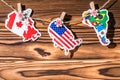 Map flag of North, South America, Canada hanging on a rope on wooden clothespins. Rustic Christmas decoration. Royalty Free Stock Photo