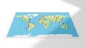 Map on a flat surface featuring countries in pale yellow and oceans in Royalty Free Stock Photo