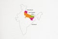 Uttarakhand, Uttar Pradesh, Bihar and Jharkhand state highlighted on Indian map on textured paper background.