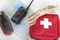 Map, gps navigator, portable radio, rope and first aid kit on a Royalty Free Stock Photo