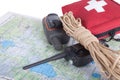 Map, gps navigator, portable radio, rope and first aid kit on a Royalty Free Stock Photo