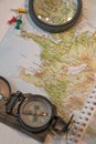 Map of Iceland, compass, lens magnifier and map push pins as ultimate items for successful traveler, abstract, background