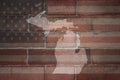 Map of michigan state on a painted flag of united states of america on a brick wall Royalty Free Stock Photo