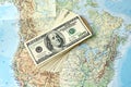 American dollars and map of North America