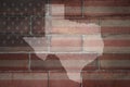 Map of texas state on a painted flag of united states of america on a brick wall Royalty Free Stock Photo