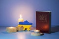 Map of Ukraine and the Bible with candle flames on a colored background. Pray for Ukraine concept