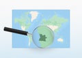 Map of the World with a magnifying glass aimed at Angola, searching Angola with loupe Royalty Free Stock Photo
