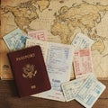A map of the world serves as a backdrop for a collection of travel-related items. A Royalty Free Stock Photo