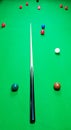 Maple and ebony cue on a snooker table with balls