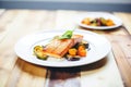 maple glazed salmon with roasted vegetables on plate