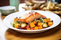 maple glazed salmon with roasted vegetables on plate