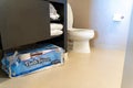 Kirkland Signature bathroom toilet paper tissue package stored under a bathroom cabinet