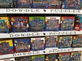 Large display of Dowdle Folk Art puzzles for sale at a Costco Wholesale warehouse store