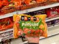 Hand holds a bag of Brachs Mellowcreme Pumpkins Halloween Candy for sale at a grocery Royalty Free Stock Photo