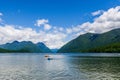 MAPLE RIDGE, CANADA - JUNE 28, 2020: Alouette Lake view from South Beach green mountains and white clouds Royalty Free Stock Photo