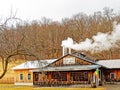 Maple sugar house with steam from smokestack Royalty Free Stock Photo