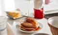 Maple Syrup Being Poured On Stack Of Freshly Made Pancakes Or Crepes On Table For Pancake Day Royalty Free Stock Photo