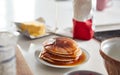 Maple Syrup Being Poured On Stack Of Freshly Made Pancakes Or Crepes On Table For Pancake Day Royalty Free Stock Photo