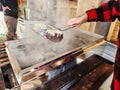 Maple syrup boilling in evaporator tub with skimmer in maplehouse. Maple farming. Tools and equipment. Royalty Free Stock Photo