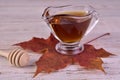 Maple syrup in a decanter on a red maple leaf. Royalty Free Stock Photo