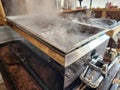Maple syrup evaporator tub in maplehouse boilling maple sugar water. Tools and equipment. Royalty Free Stock Photo