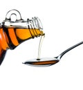 Maple syrup pouring on spoon Royalty Free Stock Photo