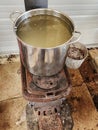 Maple syrup water boilling pot on wood stove in maplehouse. Maple farming. Tools and equipment. Royalty Free Stock Photo