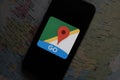Maps and iphone 11 pro with the Google Maps logo Royalty Free Stock Photo