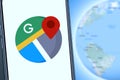 Maps and iphone 11 pro with the Google Maps logo Royalty Free Stock Photo