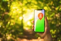 Maps on the smartphone in forest background. Outdoor navigation, hiking in forest concept photo Royalty Free Stock Photo