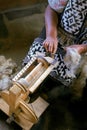 Mapuche woman hands works her handloom.