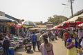 Indian street market under sunny umbrellas, a lot of people walk between the malls Royalty Free Stock Photo