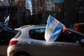 Hand holding Argentina flag from car durin Independence day